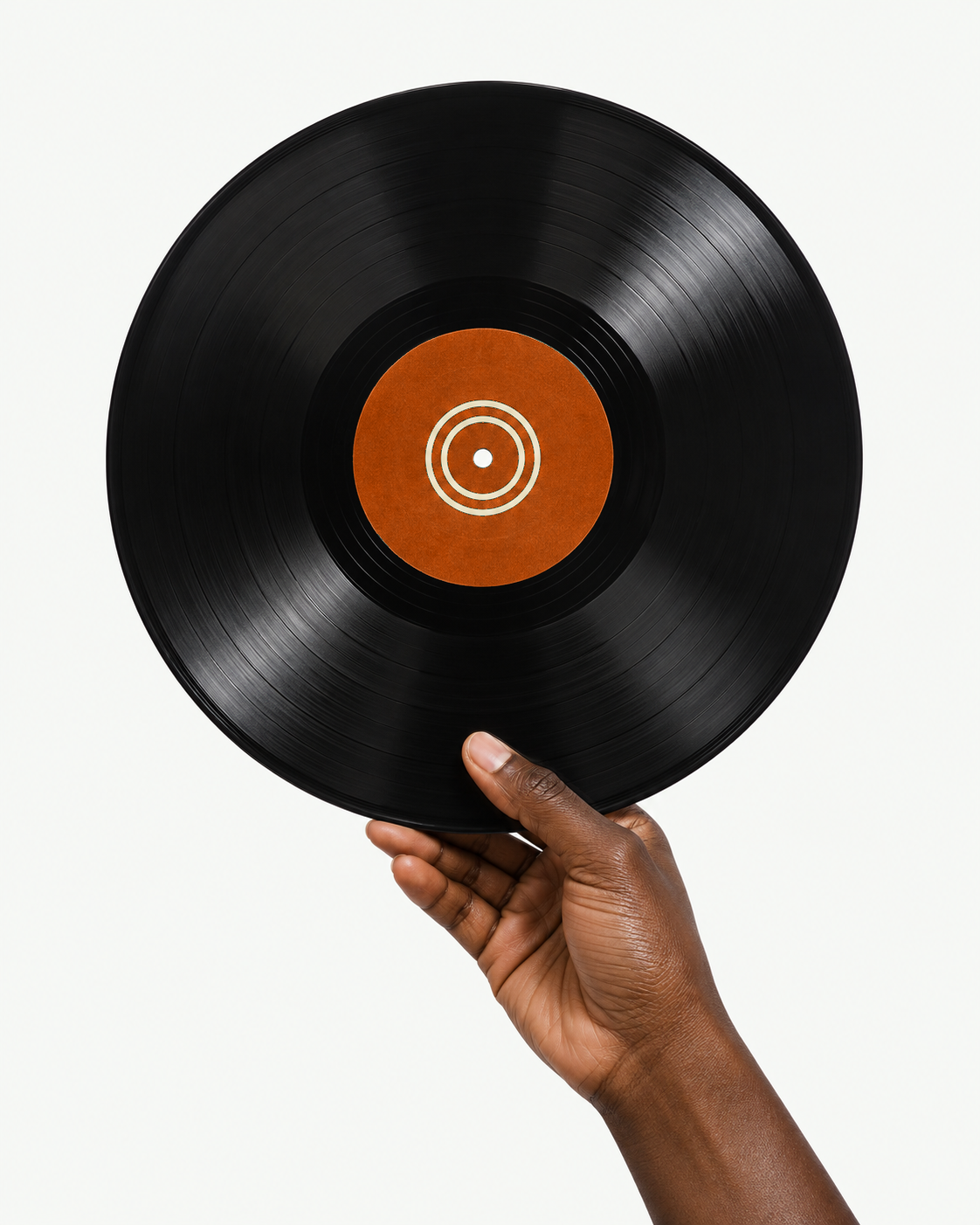 A hand holding a vinyl record with an emerald centre label